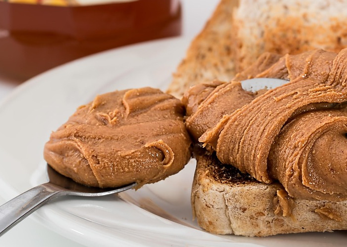 What is peanut oil? Bottle of peanut oil and raw peanuts